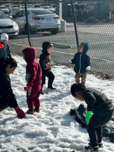 A group of children playing in the snow.