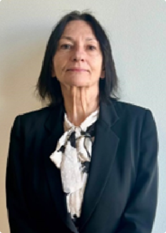 A woman in a suit and tie standing up.