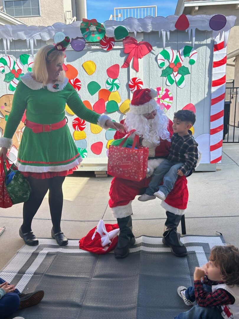 A woman in a santa claus costume with children.