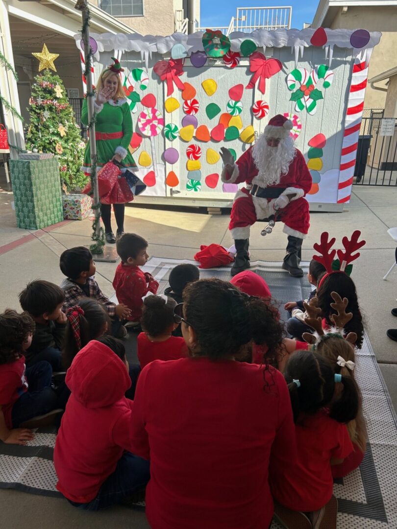 A group of children are watching a santa claus.